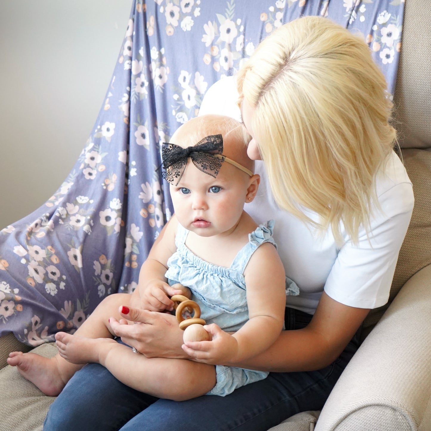 baby girl and mom with swaddle, black raven lace bow, and rattle