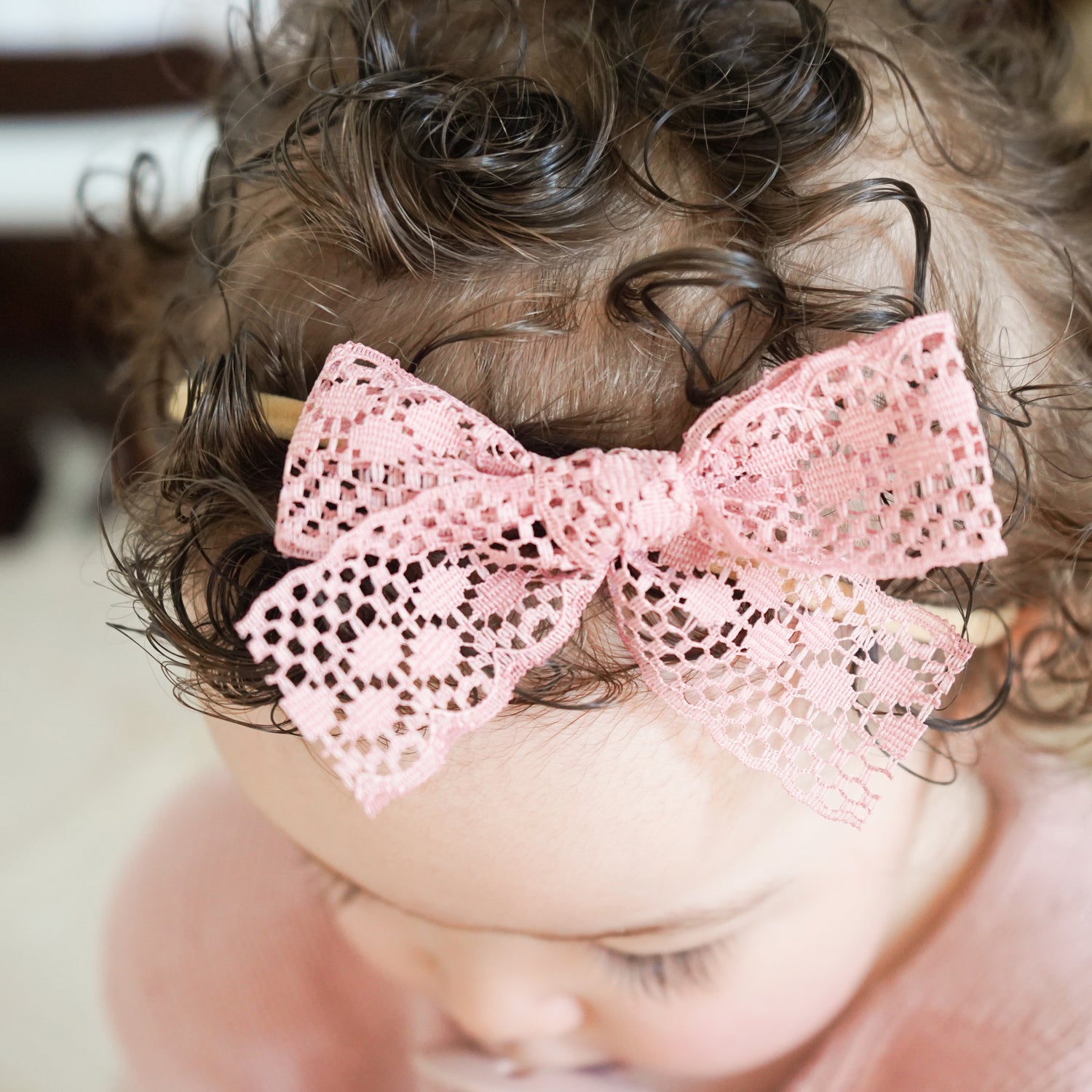 toddler wearing soft pink lace bow headband