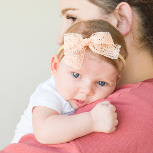 mom and baby snuggling peach lace bow headband