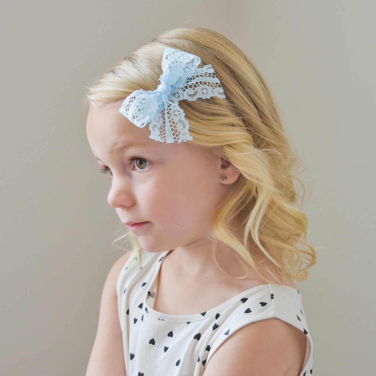 little girl with village baby blue lace bow clip