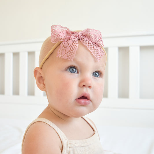 one year old wearing amelia lace bow headband