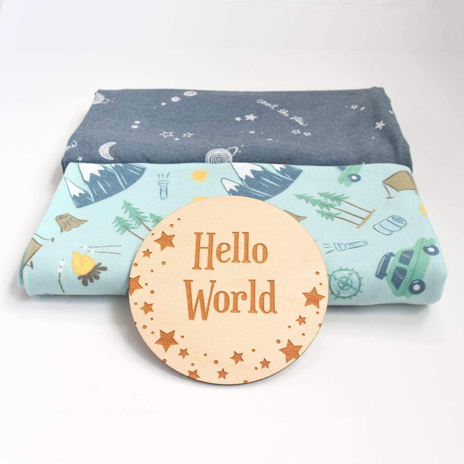 moon and stars nursery with camping and night sky swaddles and hello world engraved sign