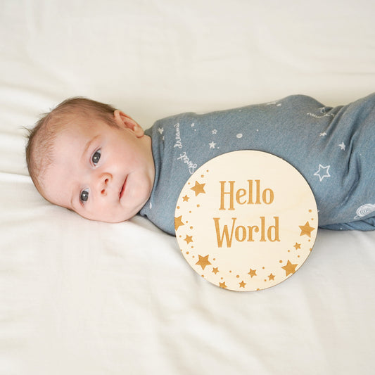baby boy in starry dreams swaddle with star hellos world welcome sign