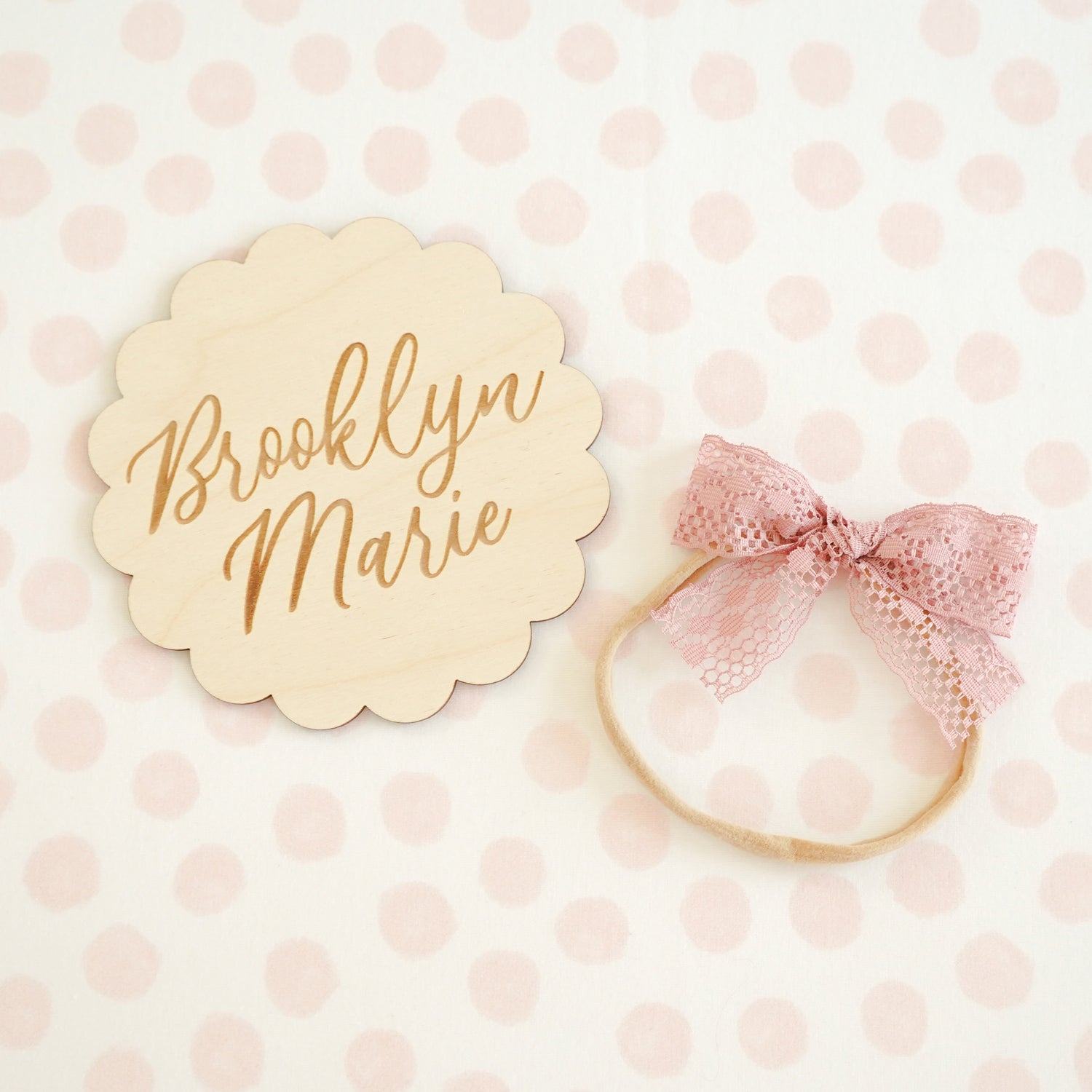 scalloped wood name sign with blush dottie blanket and lace baby bow headband