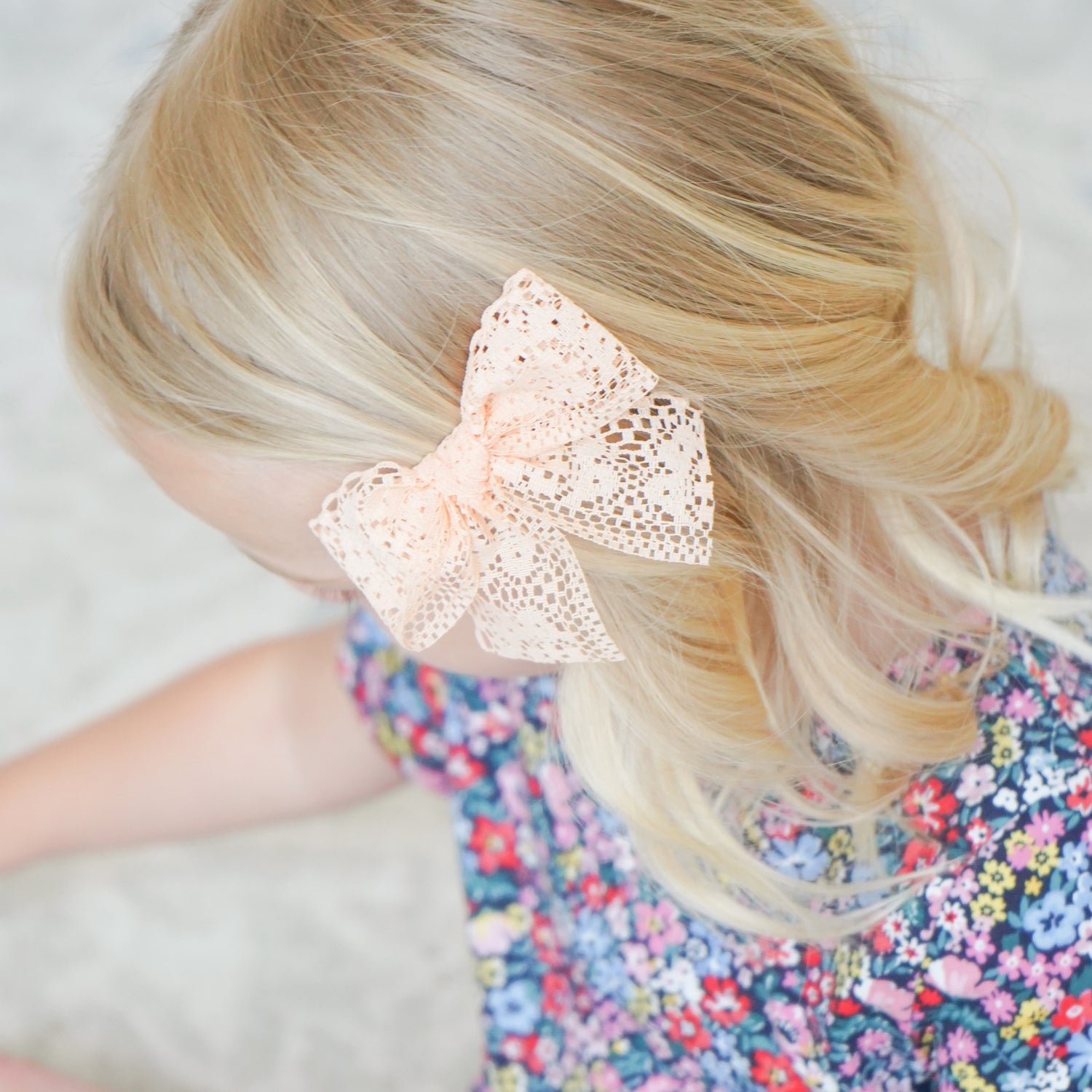 little girl wearing peach harper bow clip in hair