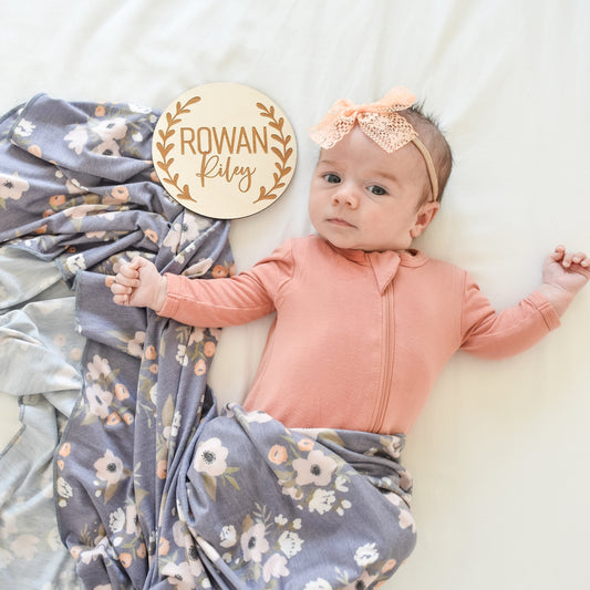 graceful greenery name sign with baby with swaddle and lace bow