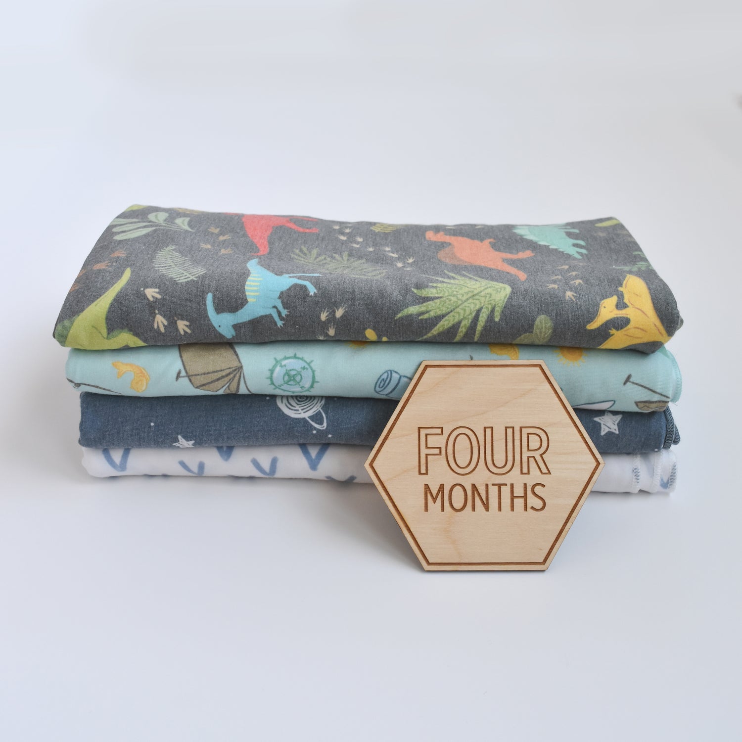 four month hexagon honeycomb shaped wooden prop with baby boy blankets