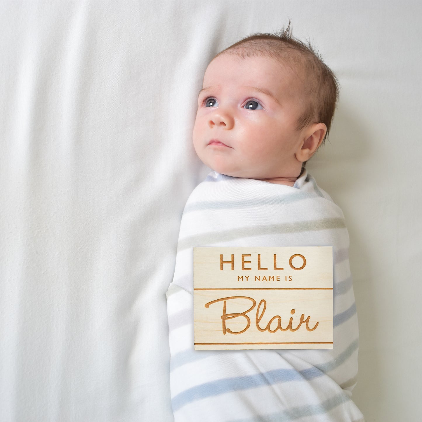 baby with hello my name is wooden badge sign birth announcement photo