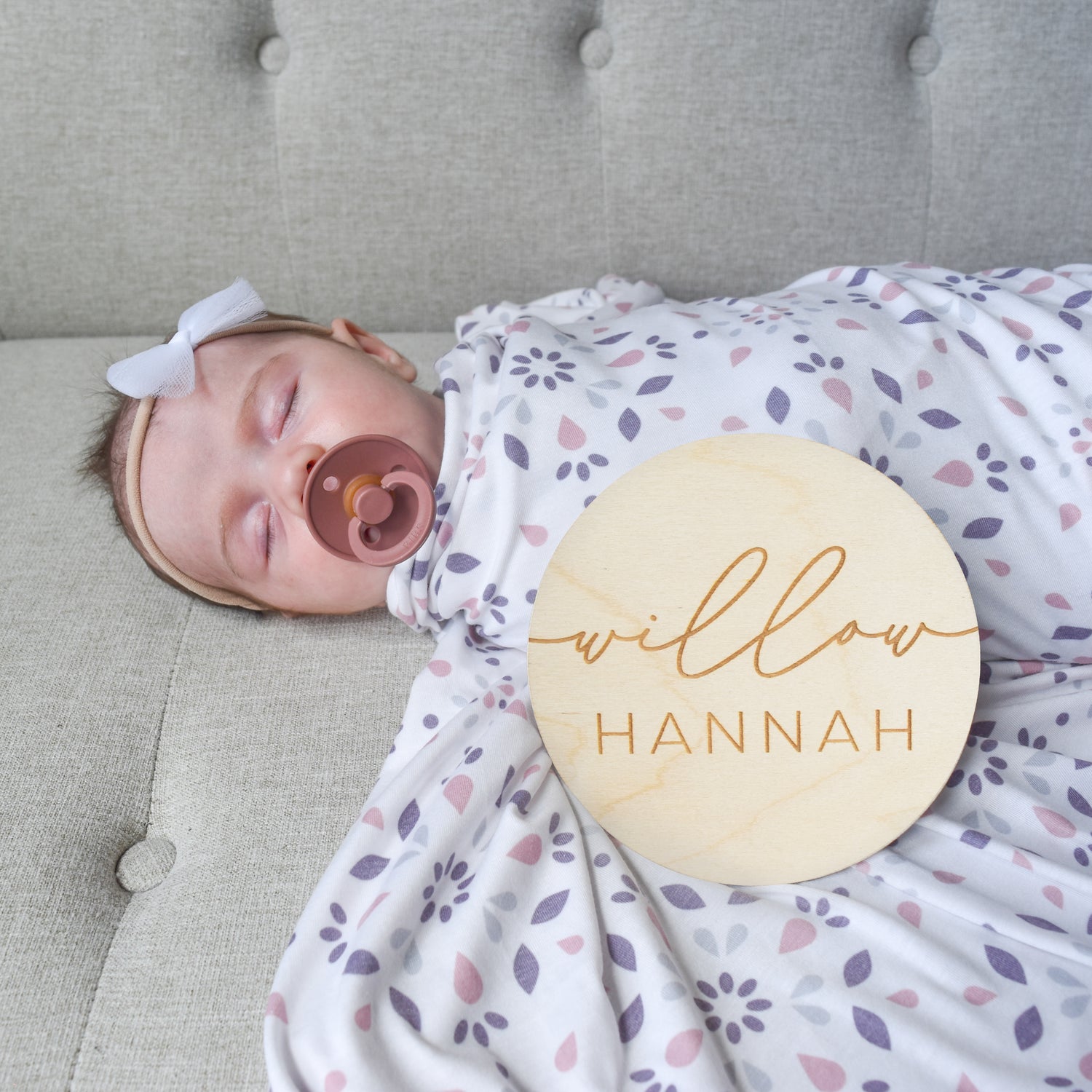 baby girl with bow, bibs pacifier, swaddle and custom name sign